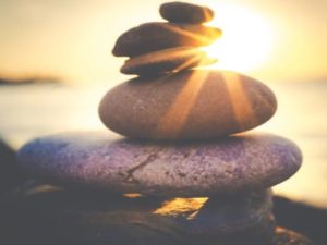 Consciously Living - Your NZ Wellness Directory - sun rays on stones