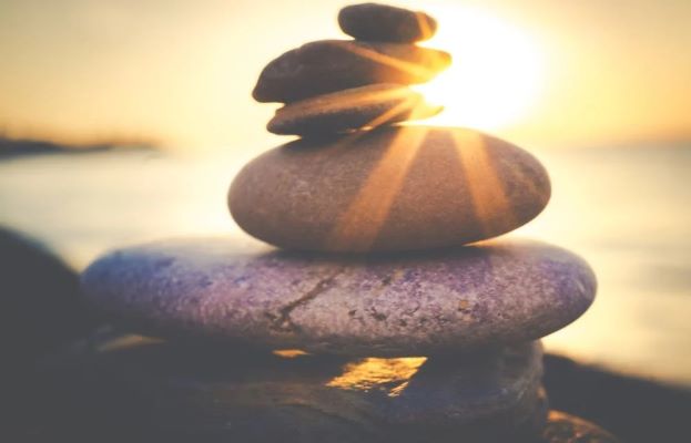 Consciously Living - Your NZ Wellness Directory - sun rays on stones